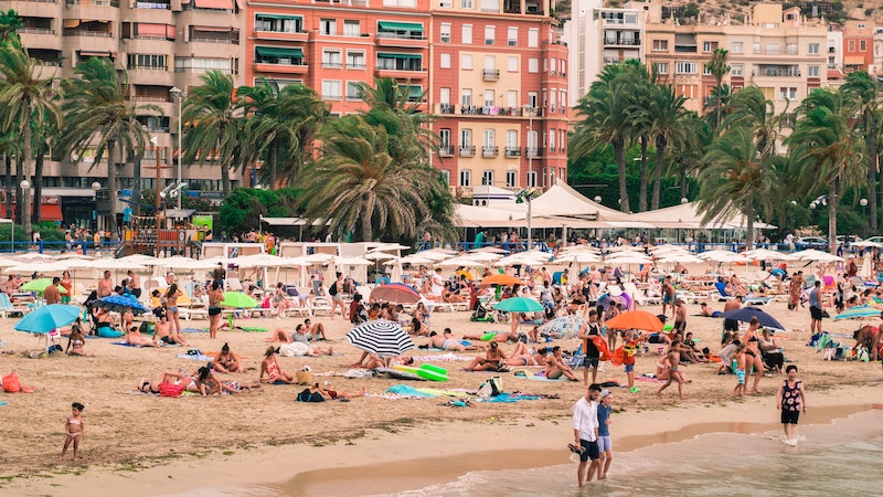 Tourists and sunbathers on a beach in Alicante, Spain