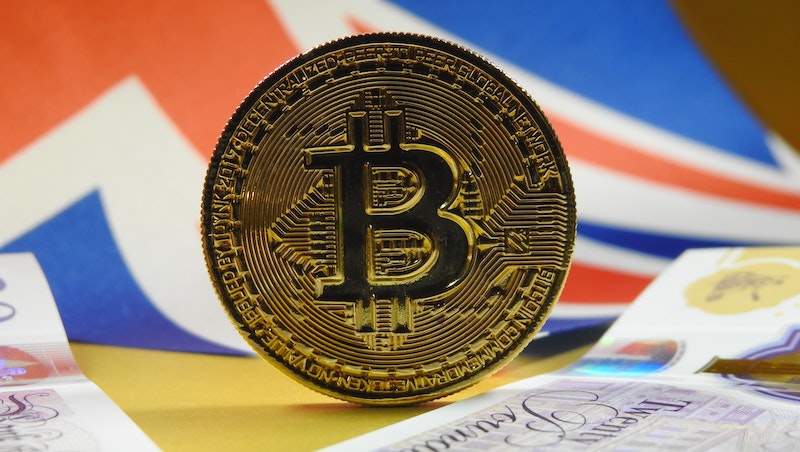 Bitcoin against a backdrop of the British flag and £20 notes