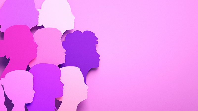 International Women's Day poster with silhouettes of multicultural women's faces in paper cut style and copy space. Sisterhood, female independence and equality