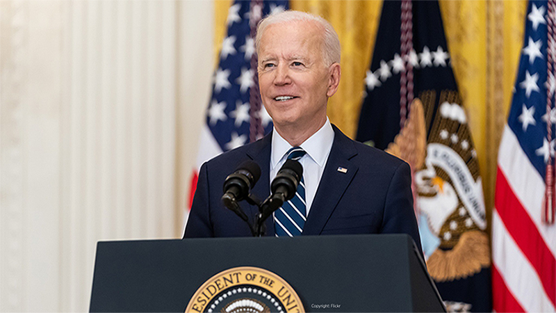 US President Joe Biden stands at a Podium at the White House
