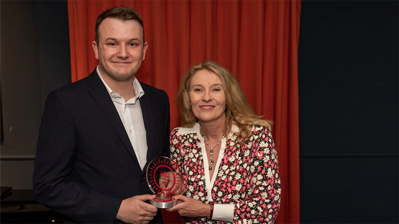Christian Mayes receives his award from the AIC's Annabel Brodie-Smith