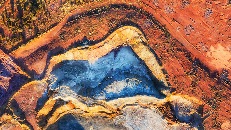 Colourful top down aerial view over open pit mine in Cobar copper town of Outback Australia.