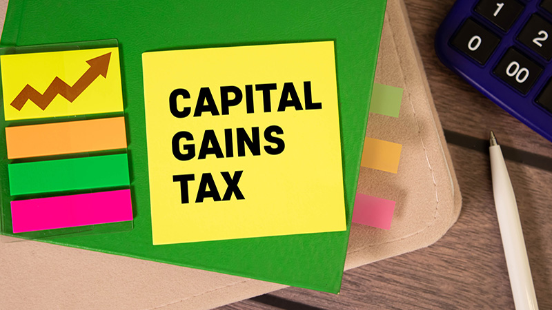 Capital gains tax-text label in the form of a document Registrar planning folder. Mandatory gratuitous payment is established by law by the state government.