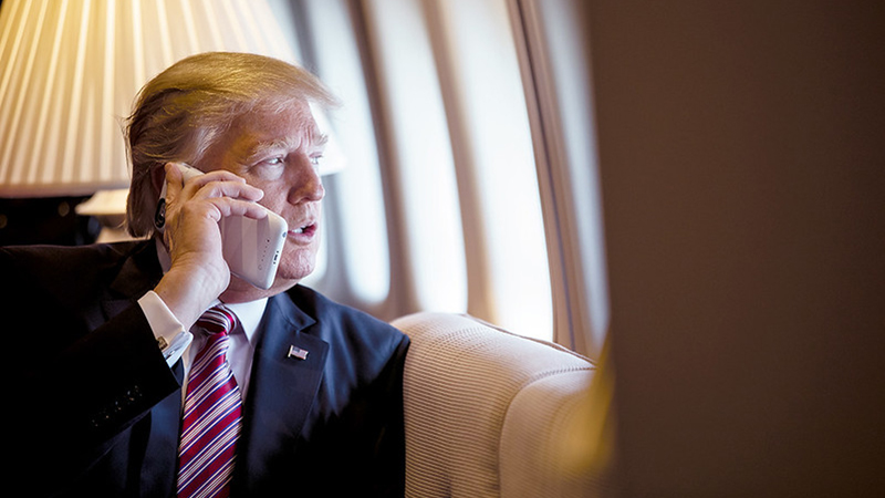 President Donald Trump talks on the phone aboard Air Force One during a flight to Philadelphia, Pennsylvania, to address a joint gathering of House and Senate Republicans, Thursday, January 26, 2017. This was the President’s first trip aboard Air Force One.