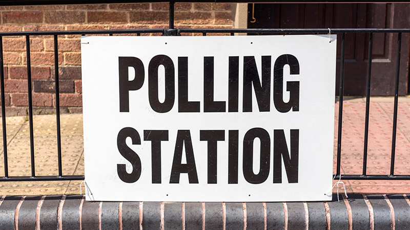A 'Polling Station' sign outside village hall during a UK election.