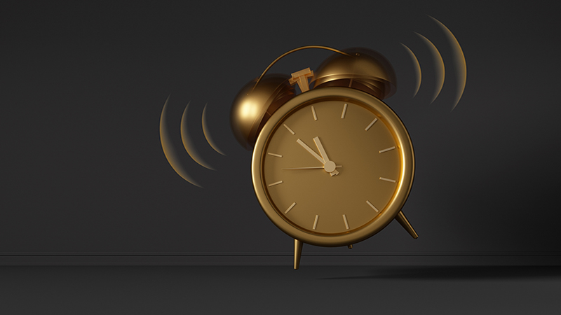 Golden ringing vintage alarm clock on dark background - modern design - 3D Illustration