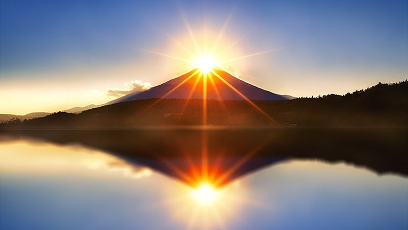 Mount fuji with diamond by lens flare on the top at Lake kawaguchiko in morning.