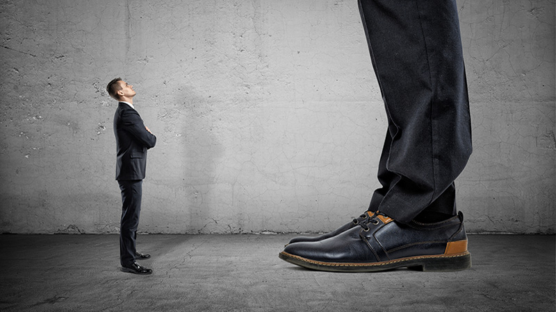 Tiny businessman looking up on huge legs of another businessman. Career growth and opportunities. Confident behaviour.