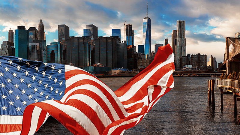 American flag flying and Brooklyn Bridge in New York City Manhattan