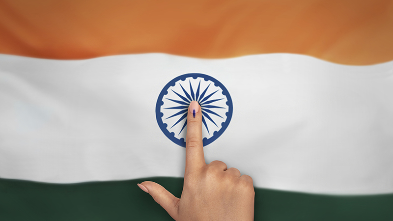female Indian Voter Hand with voting sign or ink pointing vote for India on india flag background commission of India