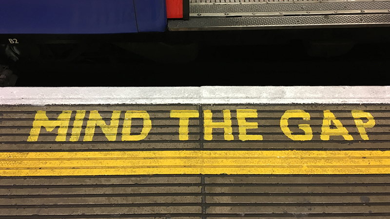 London, UK - 12 19 2017: Mind the Gap warning sign on a underground platform at a London Underground Station