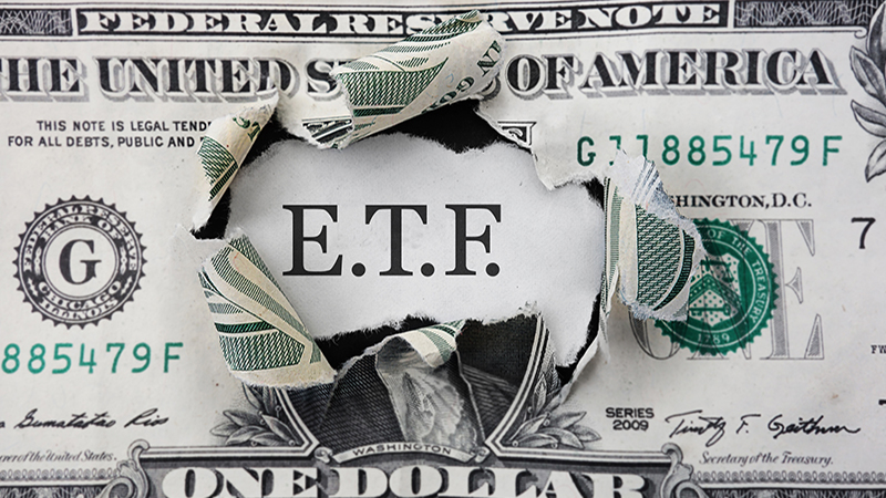 Torn dollar with ETF message, Exchange Traded Fund stock market concept