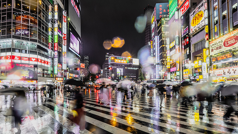 A crowded street at night in Shinjuku, Tokyo, Japan.