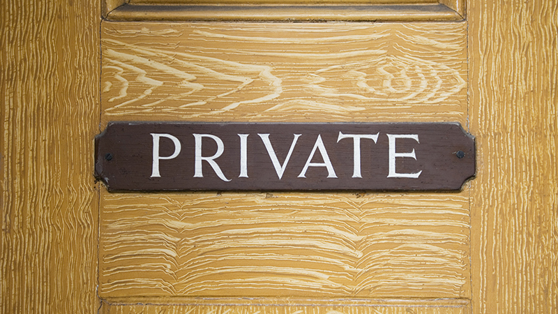 Private sign on wooden door.