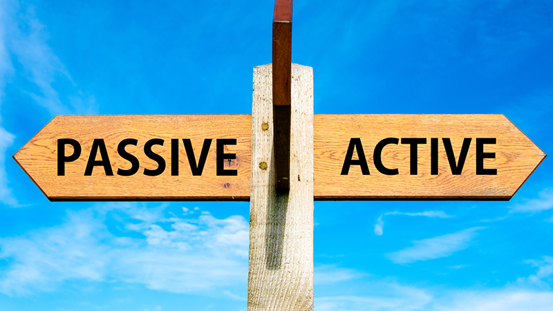 Wooden signpost with two opposite arrows over clear blue sky, Passive versus Active messages, Lifestyle change conceptual image