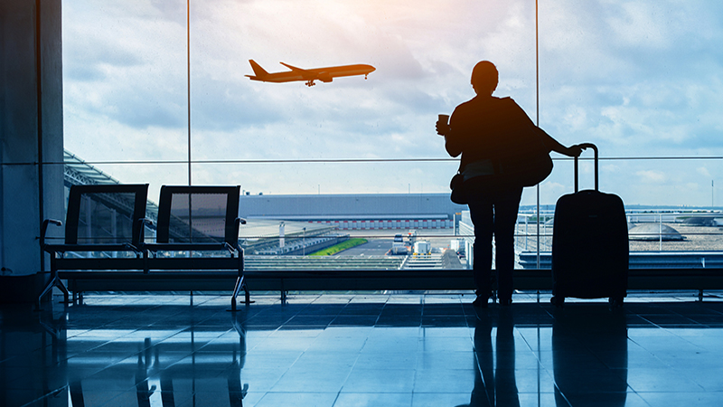 travel by plane, woman passenger waiting in airport, silhouette of passenger in airport watching aircraft taking off