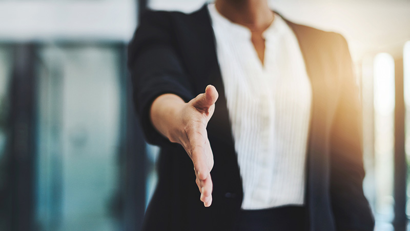 Cropped shot of an unidentifiable businesswoman extending her arm for a handshake