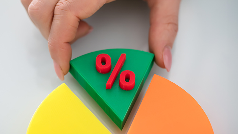 Close-up Of A Person's Finger Taking Green Piece Of Pie Chart With Red Percentage Symbol