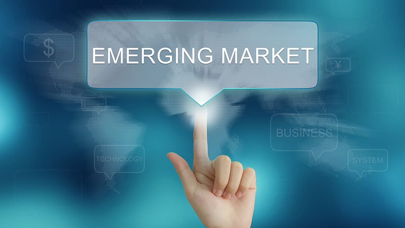 hand pushing on emerging market balloon text button : Brazil, Russia, India, China is an association of major emerging national economies